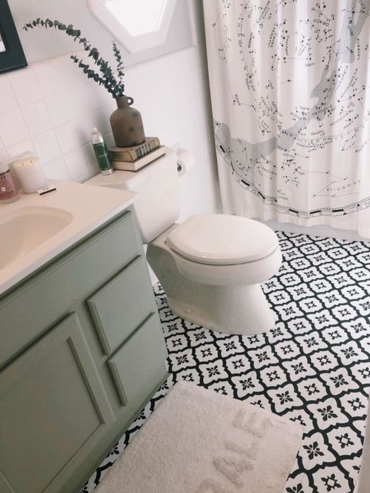 A reviewer's photo showcasing their bathroom with sleek black and white patterned floor tiles.