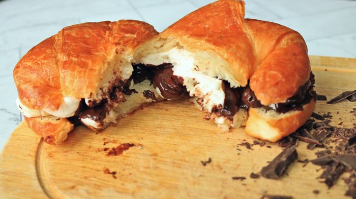Croissant s'mores arranged neatly on a cutting board.