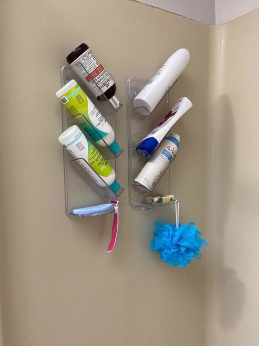 Reviewer photo showing the caddy holding six bottles and other toiletries