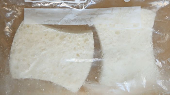 Take two frozen white sponges and place them into a plastic freezer bag.