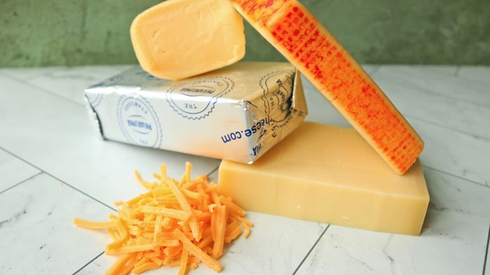 A selection of cheeses arranged neatly on a countertop.