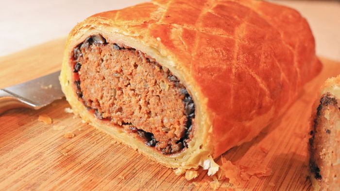 A slice of meatloaf Wellington, cut open to reveal its delicious filling.