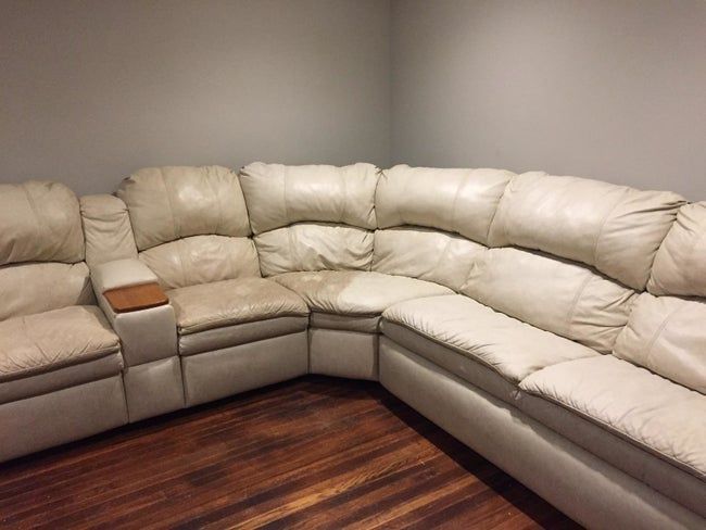 A white couch, half cleaned, showing a tan side and a bright white side