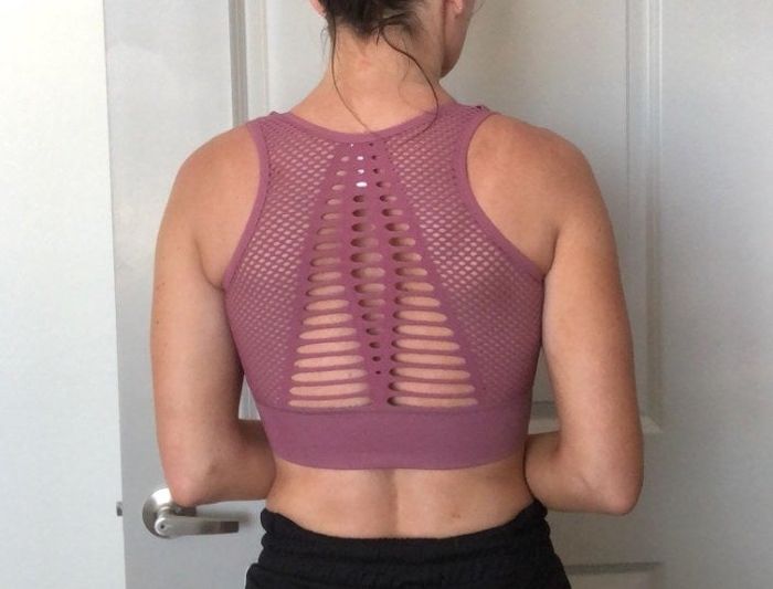 A reviewer showcasing the back of the bra while wearing it