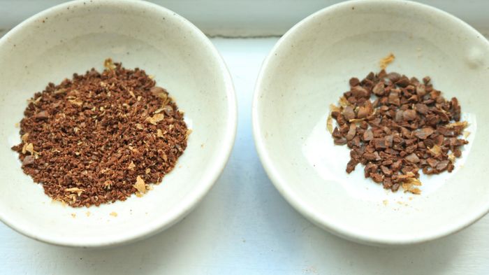 Two small bowls filled with ground coffee