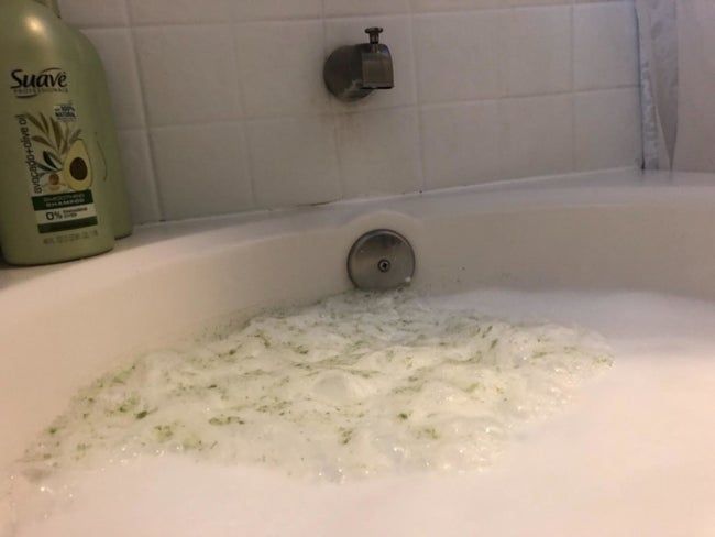 green foam, filthy, collected in the bathtub