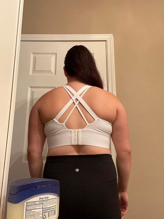 The same reviewer showing the back view of the sports bra.