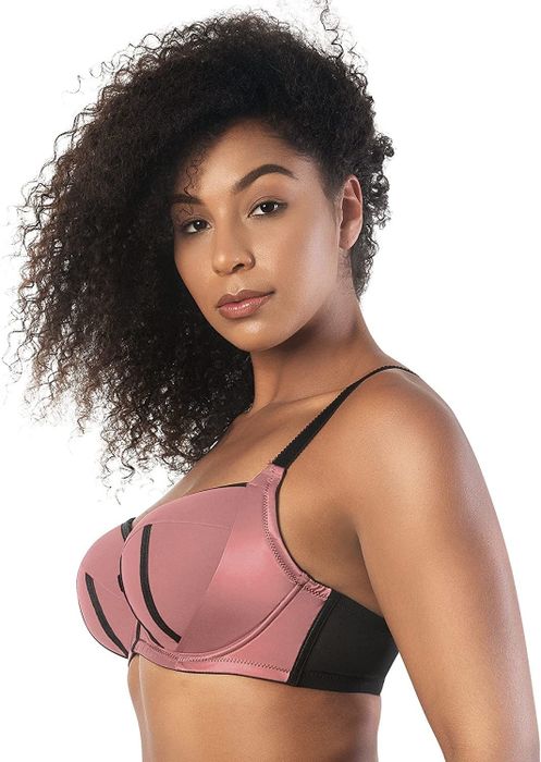 The side view of a model wearing a pink and black balconette bra.