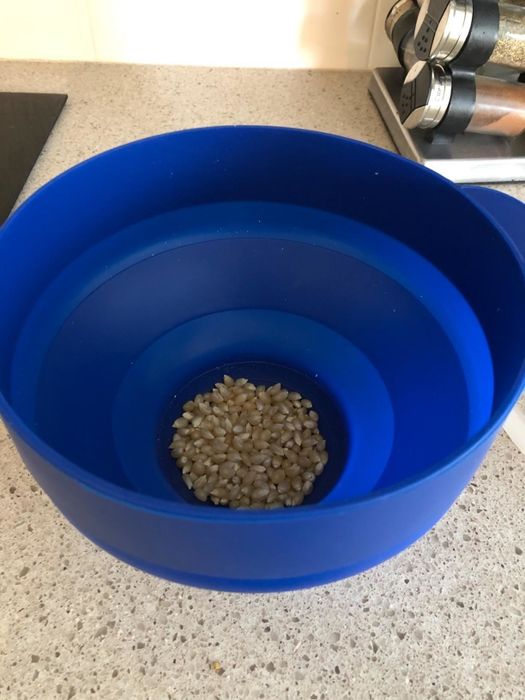 A flexible silicone bowl designed for popcorn kernels.
