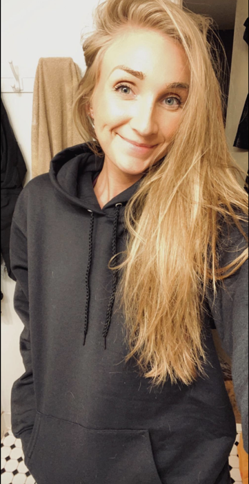 A reviewer showcasing the hoodie in black.