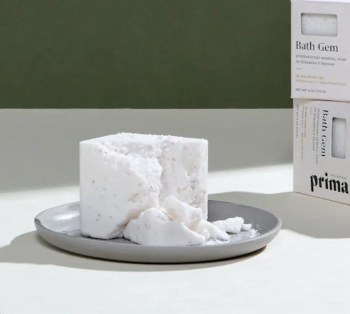 A slightly crumbled white square bath soak showcasing its textured surface.