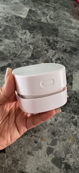 Reviewer holding the desktop vacuum