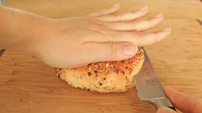 A knife cutting into a bagel