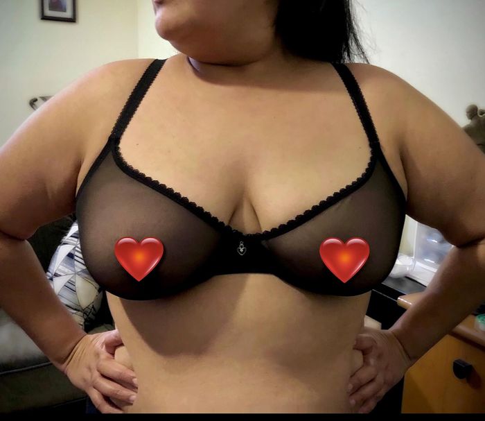 A reviewer models a black bra.