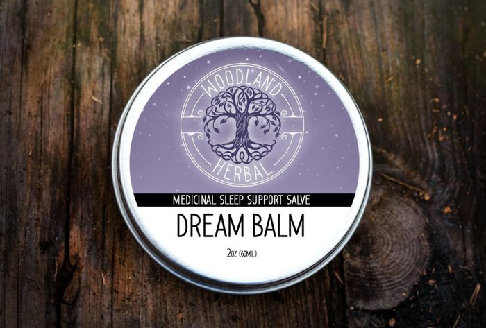 A Dream Balm in a round purple jar, perfect for bedtime relaxation.