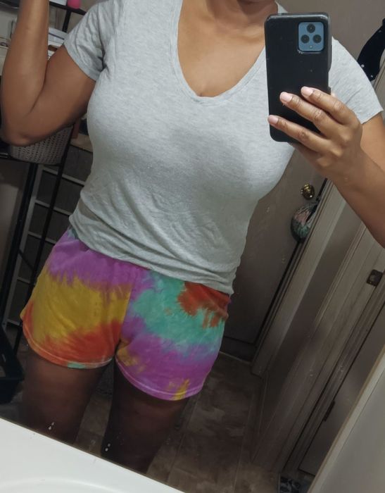 The same person showing off the bra underneath a v-neck t-shirt