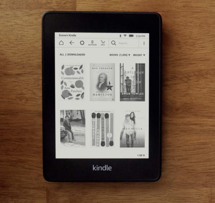 The sleek black Kindle Paperwhite displaying a digital library on its screen.
