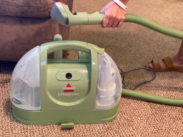 A photo from the reviewer showing the cleaner in action on a recliner