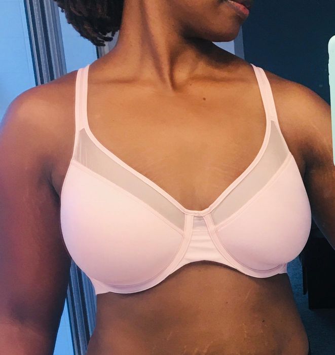A photo from a reviewer wearing the pink smoothing bra.