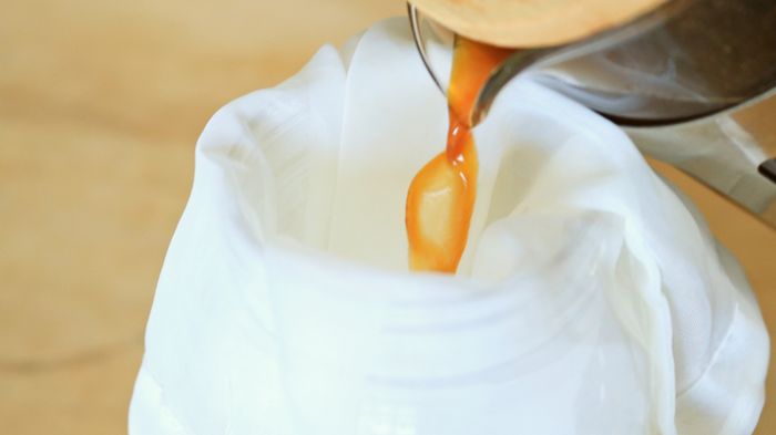 Pouring coffee into a strainer