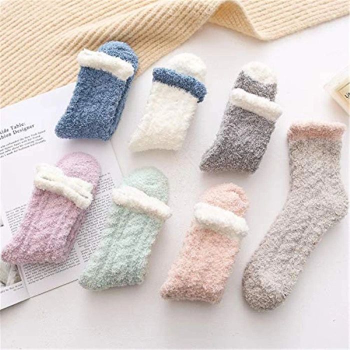 Six pairs of fuzzy socks in soft pastel colors