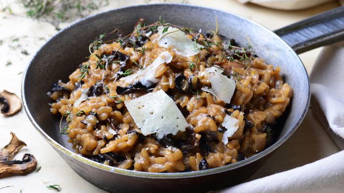 A delicious bowl of mushroom risotto topped with melted cheese