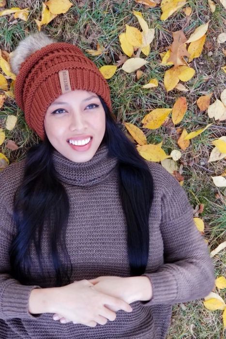 Reviewer rocking the rust-colored hat with a gray pom-pom