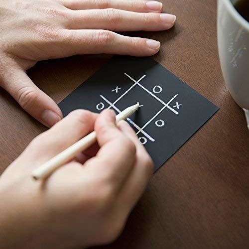 A person playing tic-tac-toe on one of the scratch-off notes
