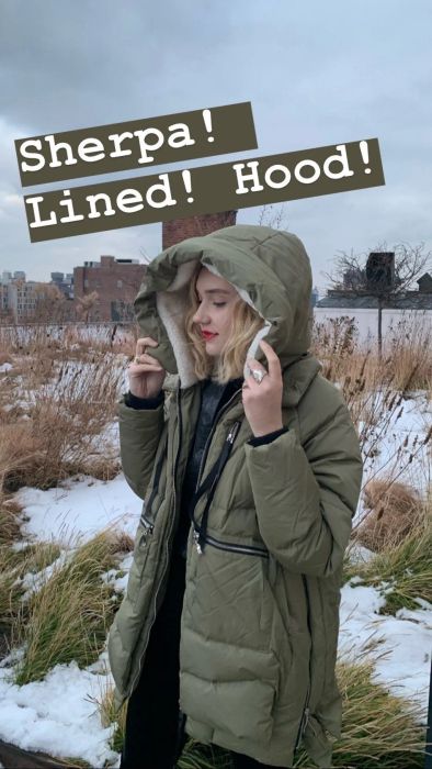 Mytour Senior Editor rocking the olive green coat with the phrase