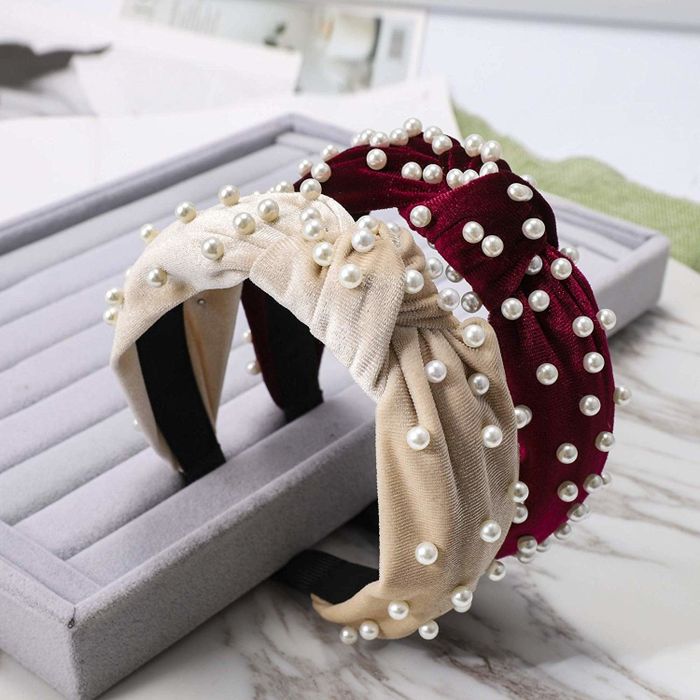 Velvet headbands featuring a knot at the top, adorned with faux pearls sewn carefully onto it