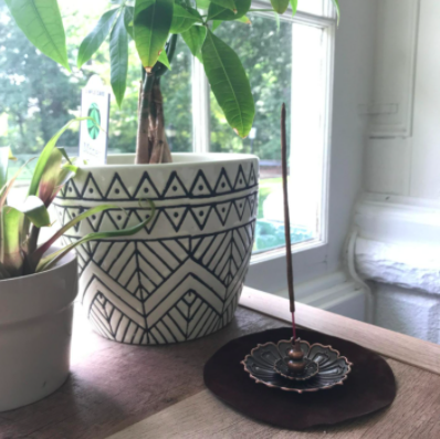 A wider shot of the incense holder, capturing its design from a distance.