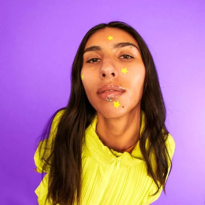 A model sporting the star-shaped pimple patches on their face.