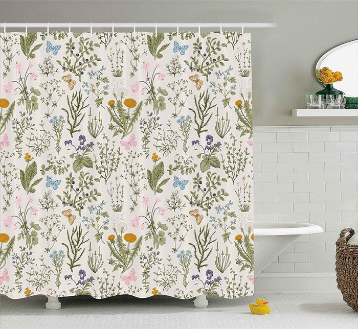 A shower curtain adorned with a floral and butterfly pattern