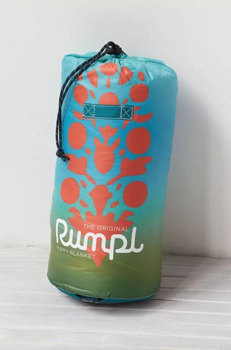 A duffle bag holding the puffy blanket