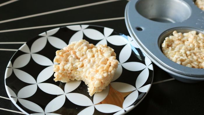A Rice Krispies treat on a chic black and white plate.