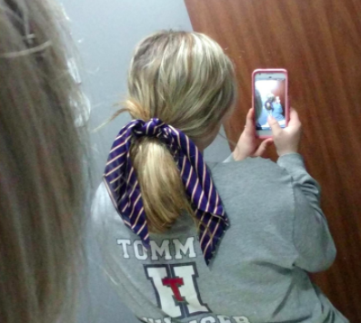 A reviewer sporting a striped scarf scrunchie in their hair