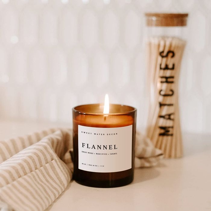A glowing candle placed on a counter