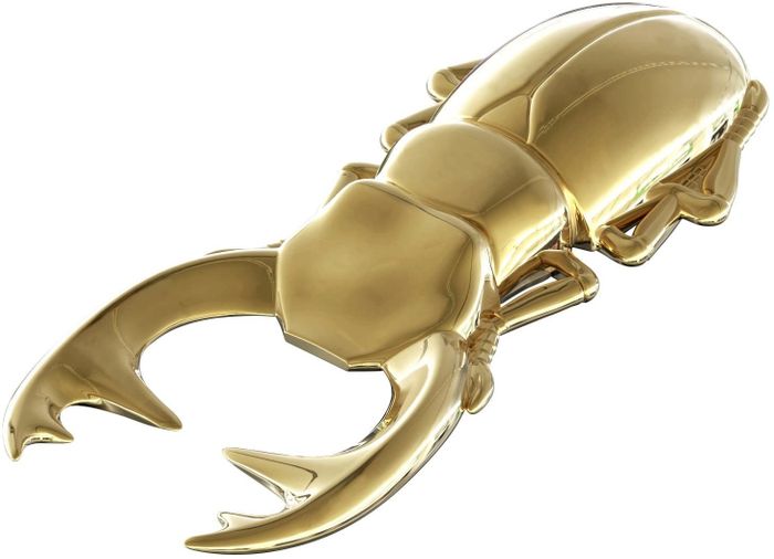 A bottle opener designed in the shape of a gilded beetle