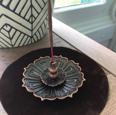 A reviewer’s photo of the lotus incense burner, showcasing its intricate details.
