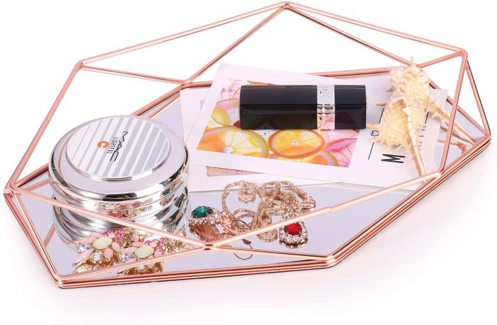 A tray featuring elegant rose gold accents with a sleek mirrored base