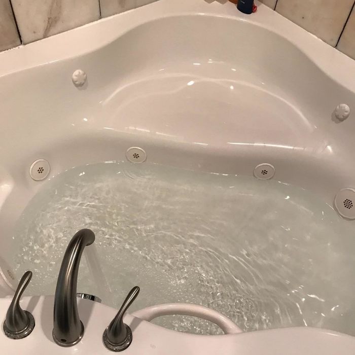 The tub is now spotless and gleaming, fully cleaned.