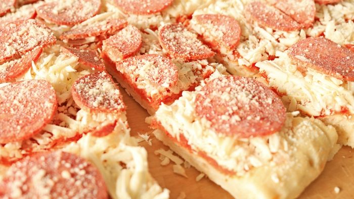 A close-up of a frozen pizza neatly divided into slices.