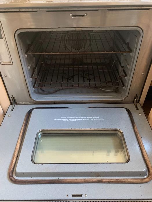 the same oven, now clean and gleaming after the cleaning process