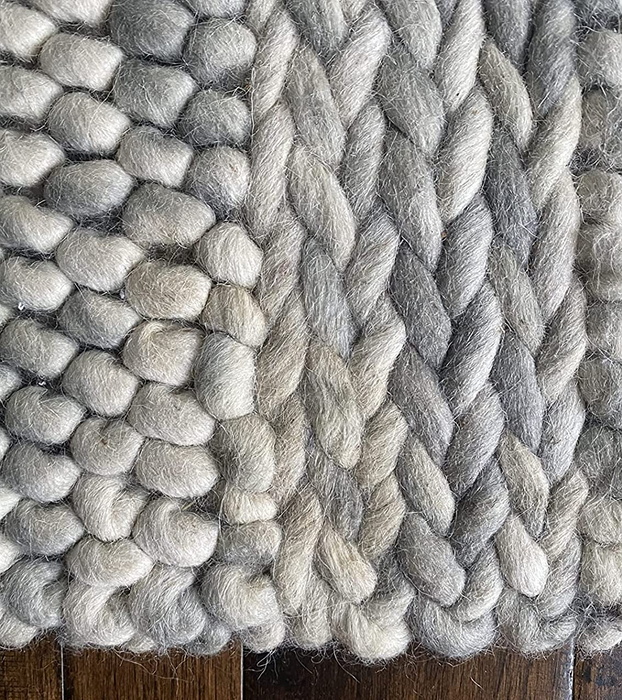 A reviewer's wool rug restored to cleanliness after using the stain and odor eliminator spray.
