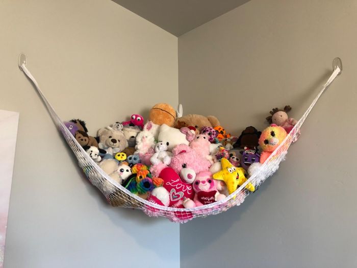 A reviewer's storage hammock filled with stuffed animals.