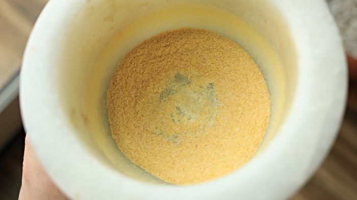 A yellow powder rests in a mortar, but there's no pestle in sight.