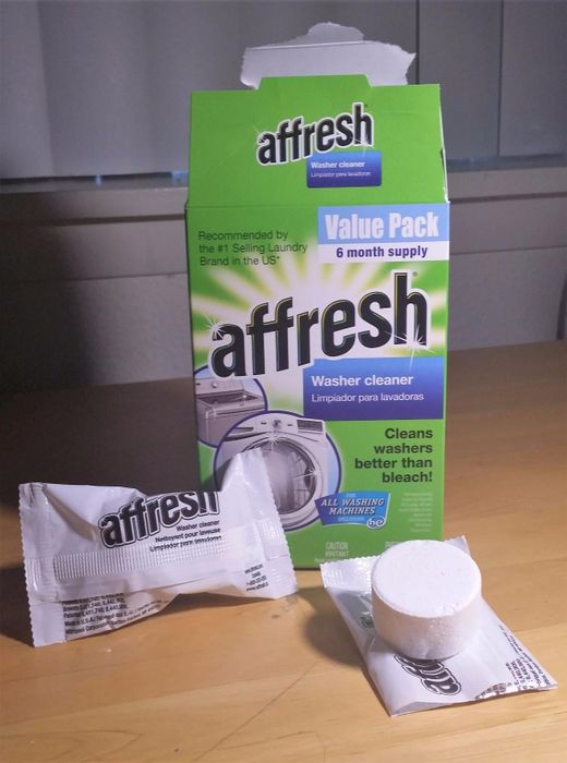 A reviewer's Affresh cleaning tablets along with their packaging.