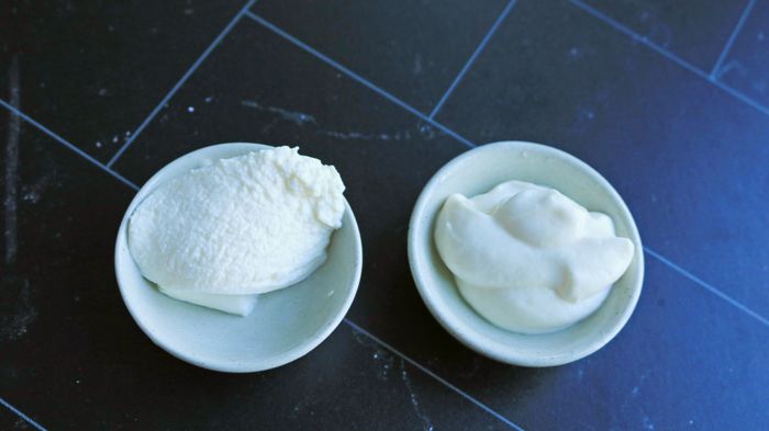 Two small bowls of ricotta cheese placed side by side.