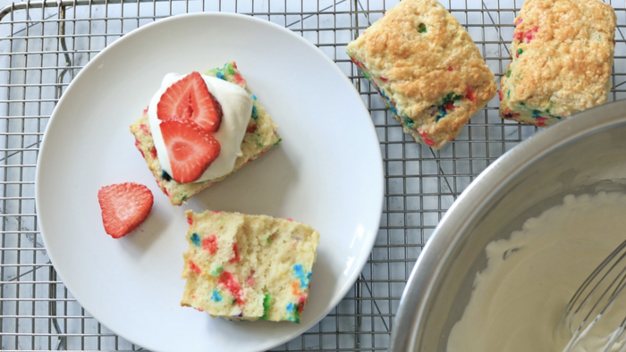 A strawberry shortcake topped with colorful confetti biscuits.