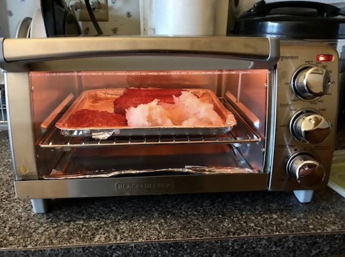 A reviewer preparing breakfast using the toaster oven
